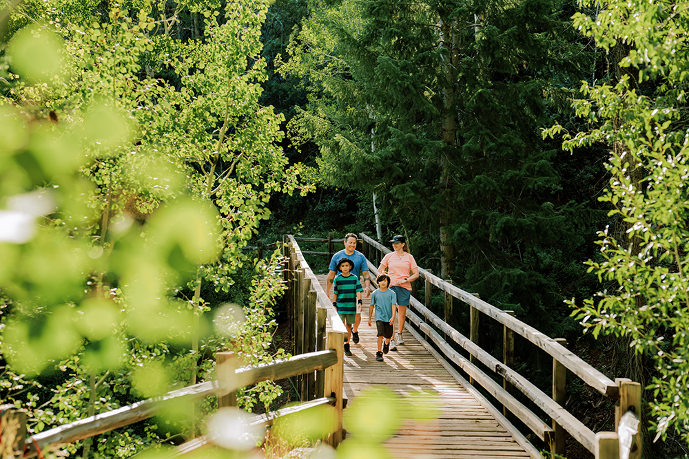 Family walking on a bridge on the Hunter Creek Loop