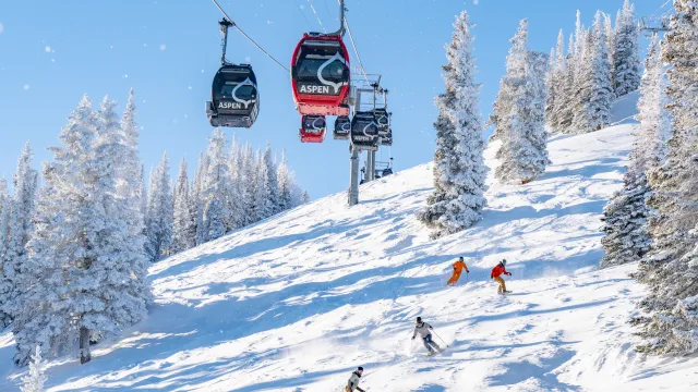 view of aspen snowmass skiers and snowboarders with a gondola in the background