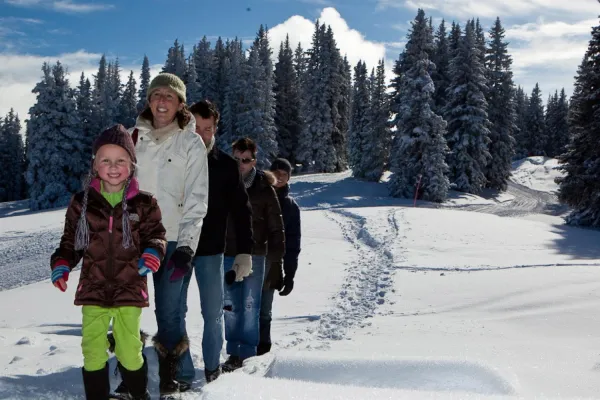 family hiking in snow