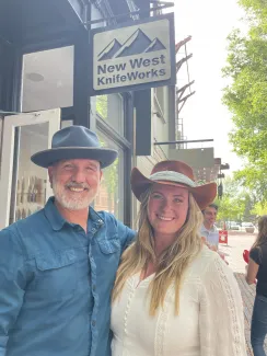 new west knifeworks signage outfront the store and smiling attendees