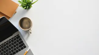 desk with laptop and pen